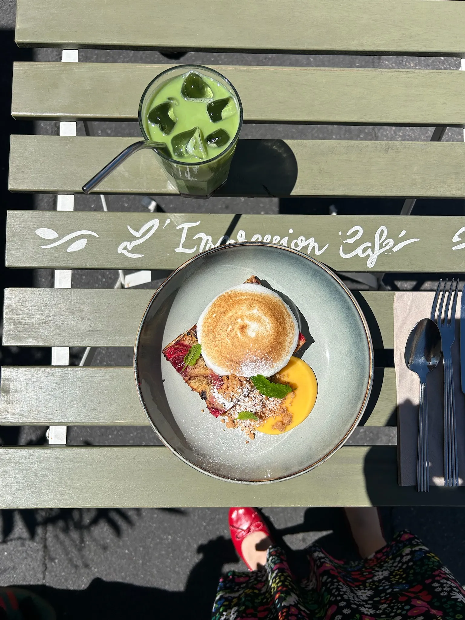 Meringue dessert and iced matcha drink on a wooden table