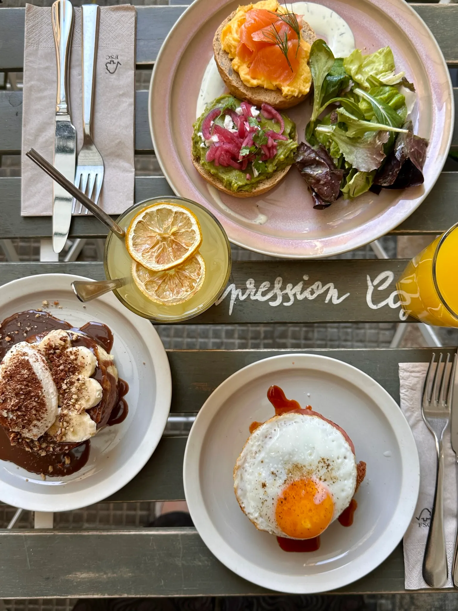 Smoked-salmon bagel, avocado toast and fried egg seen from above