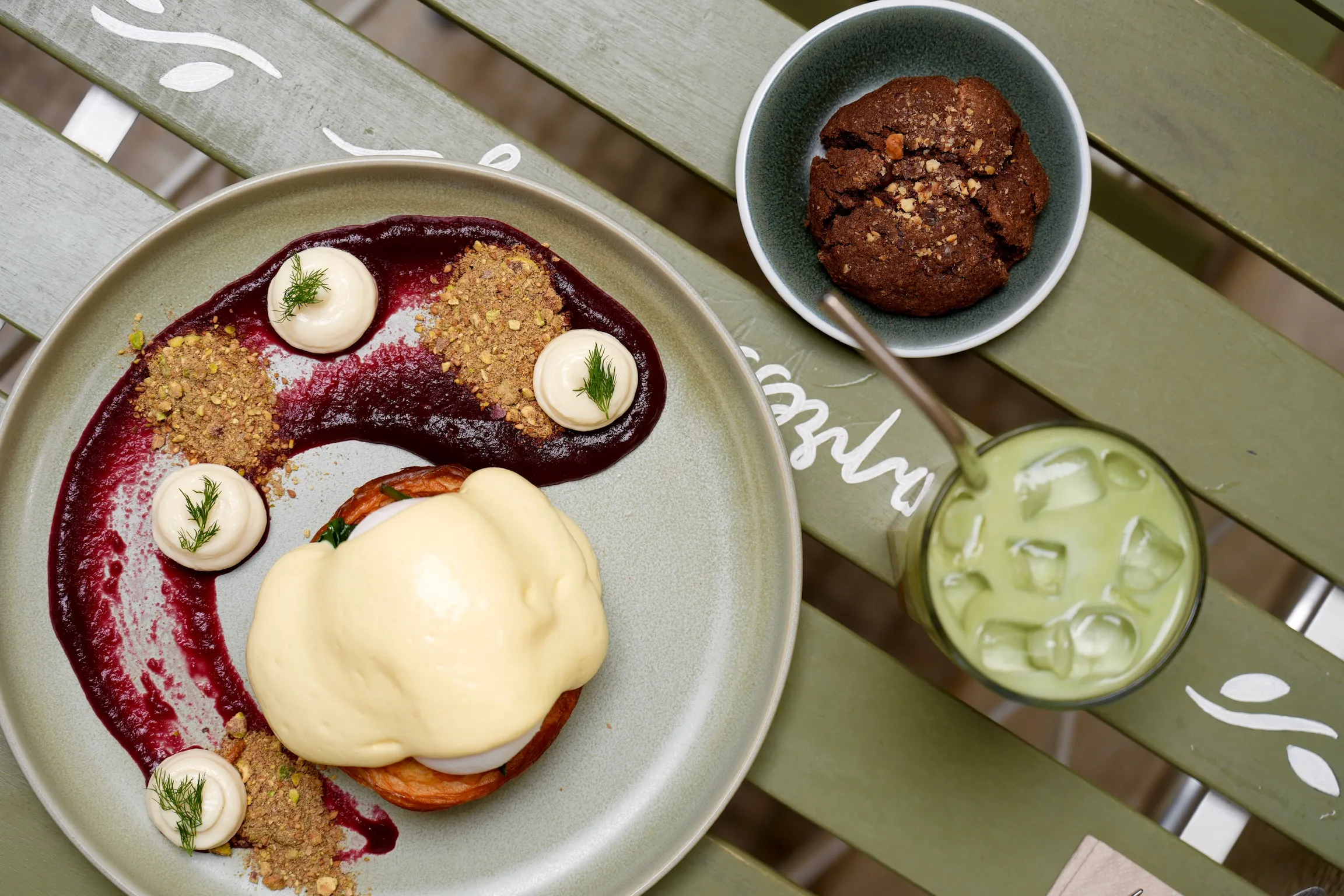 Homemade dishes seen from above: eggs Benedict, pastries and sweet treats