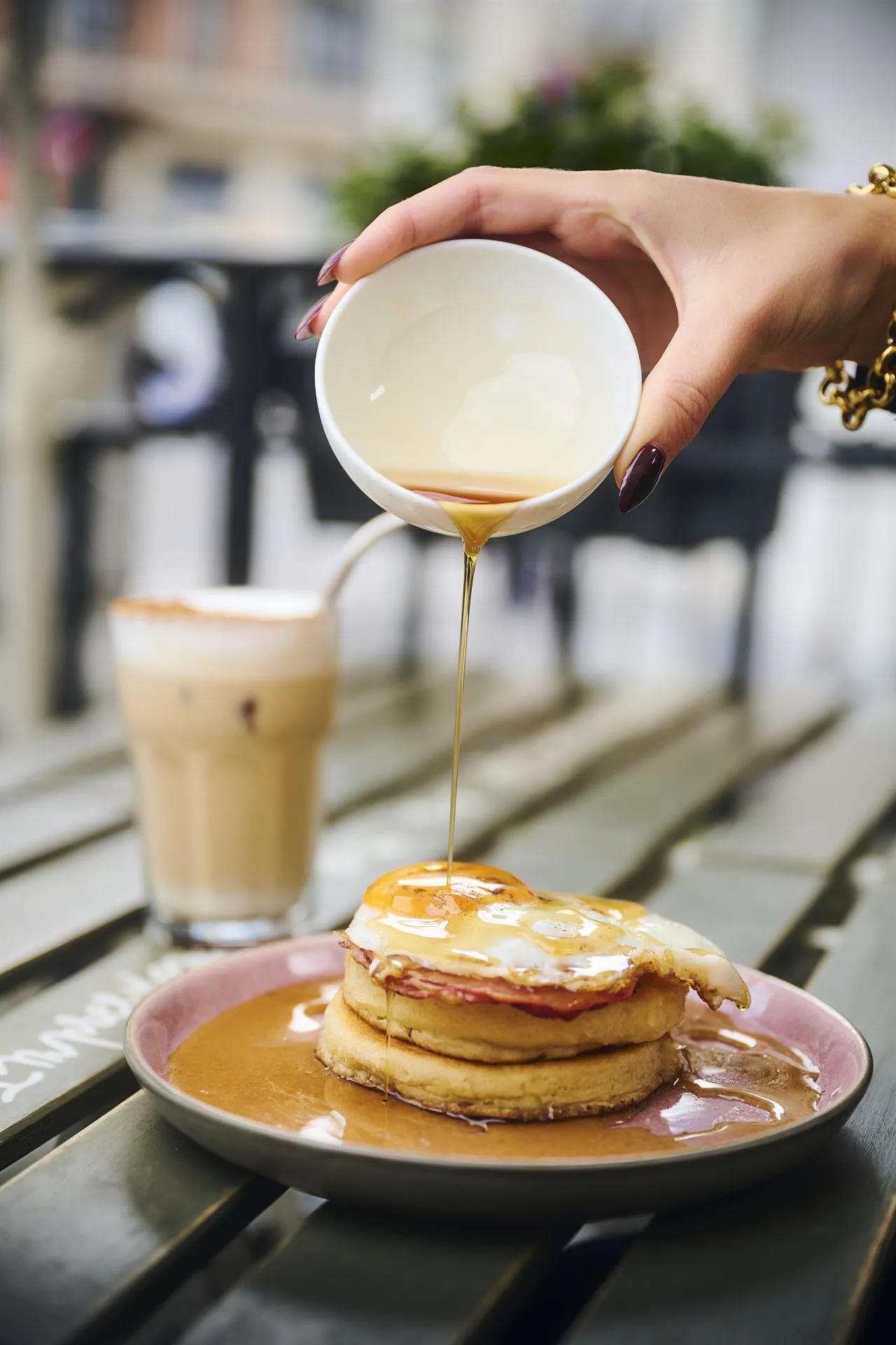Maple-syrup pancakes and a brunch table set in the sun on the terrace of L'Impression Café