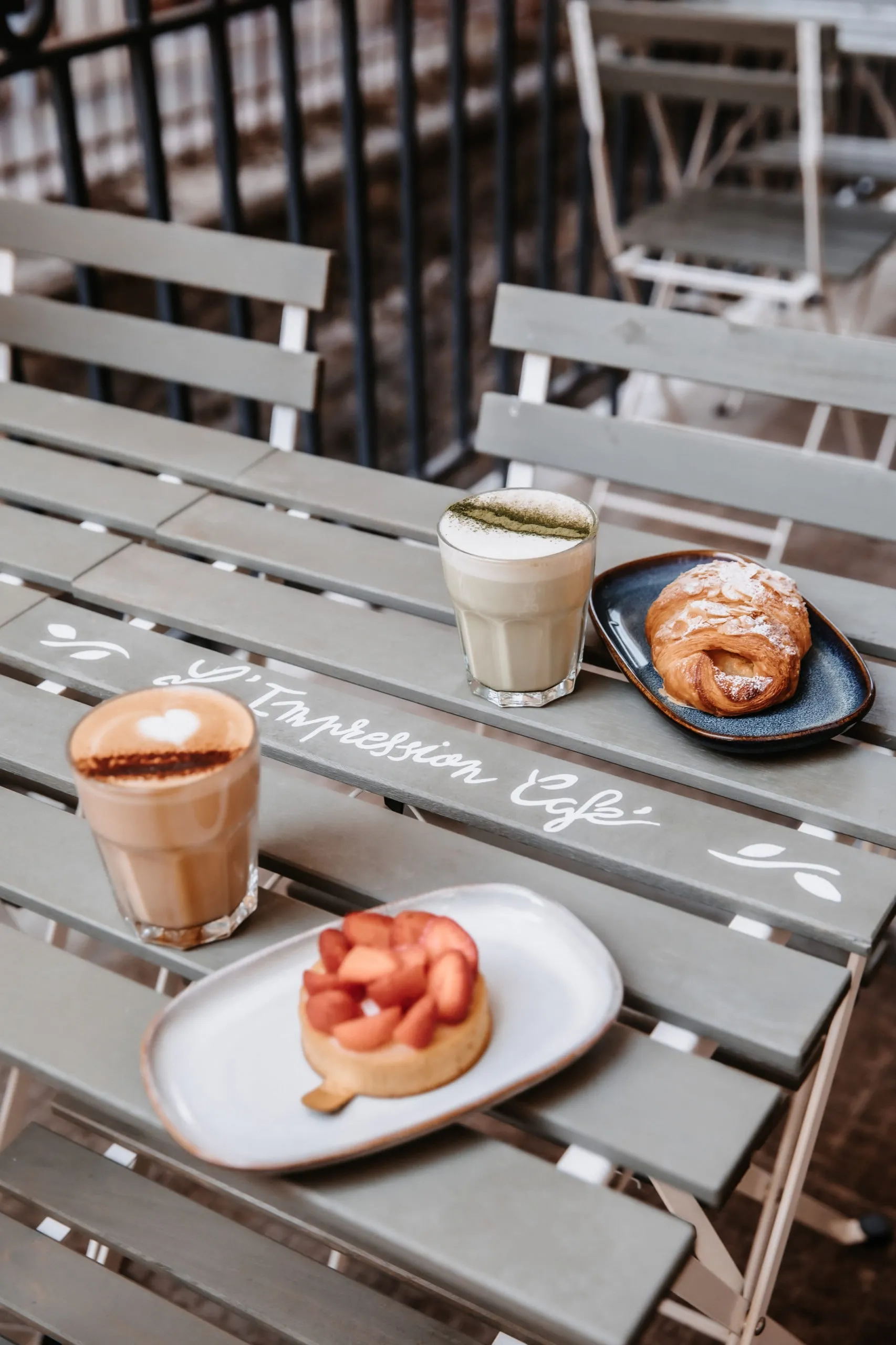 The terrace: latte, matcha and pastries on the hand-painted tables.